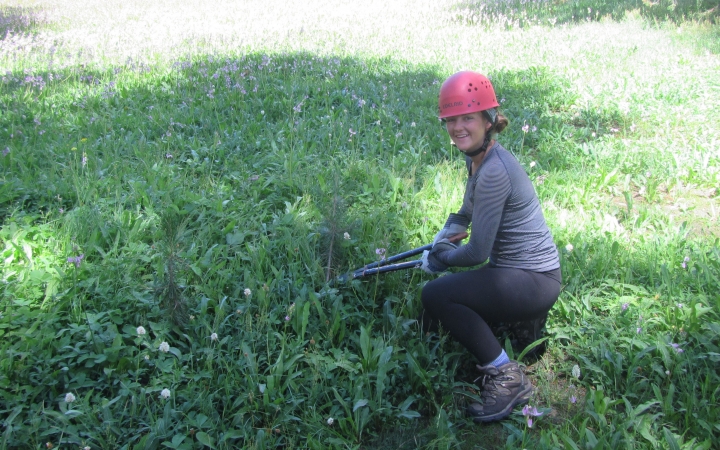 A person uses garden tools during a service project with outward bound